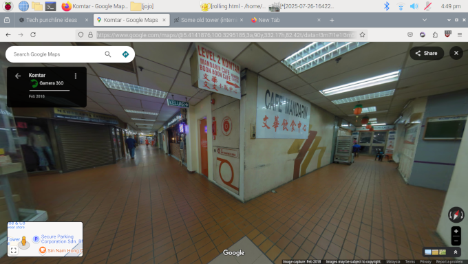 This is a Street View of the inside of KOMTAR that one Gamera 360
			uploaded to the Google Maps system in 2018. The image here shows a corner of it's hallway system. Visible: 
			fire safety doors marked as escape stairs and hose reel in the corner,
			a old fashioned low ceiling-tiles ceiling, brown rectangular floor tiles, 
			and a sign momunted to the wall for "Cafe Mandarin", among other things.